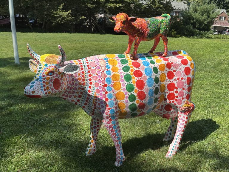 Colorful cow sculpture duo